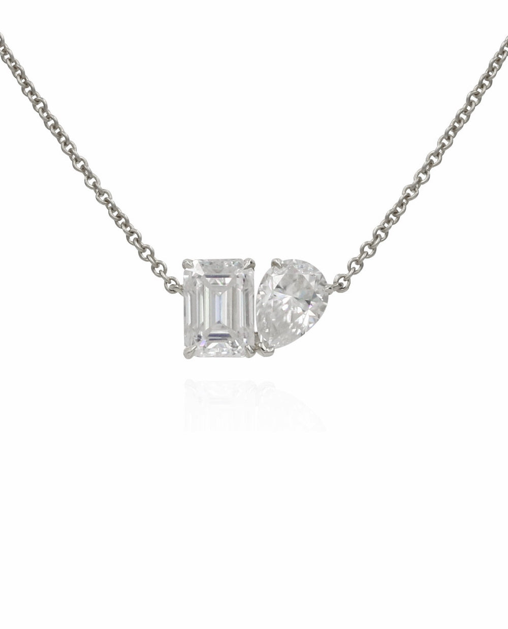Diamond necklace with two gemstones on a white background